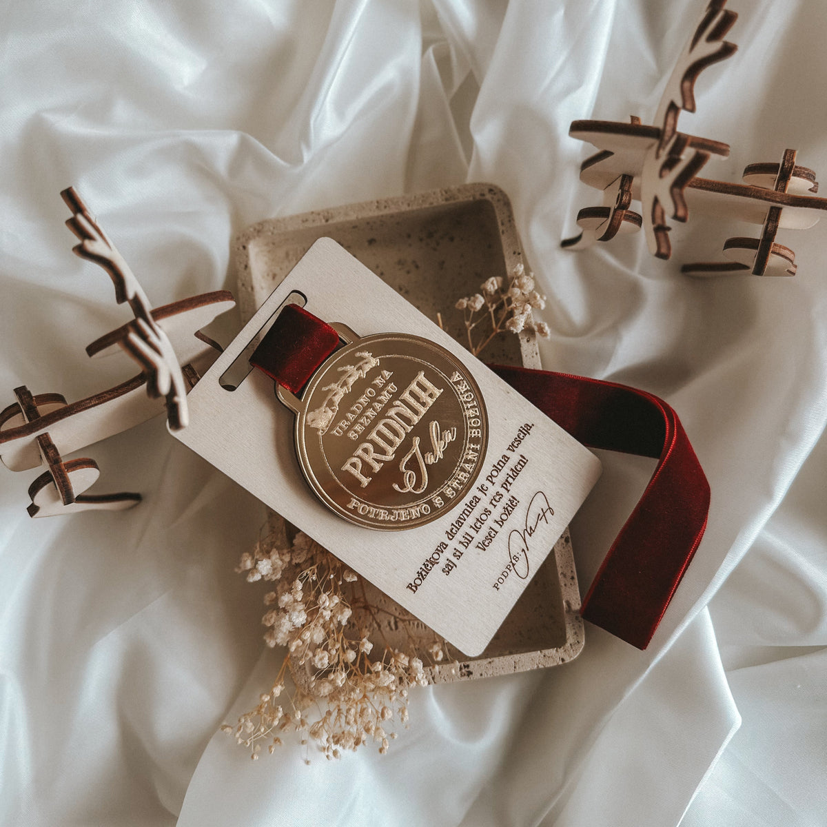 Decorative medal with a label and ribbon on a white fabric background